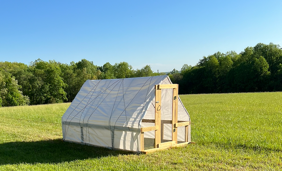 Pasture poultry shelter at Franklin Acres in a green field